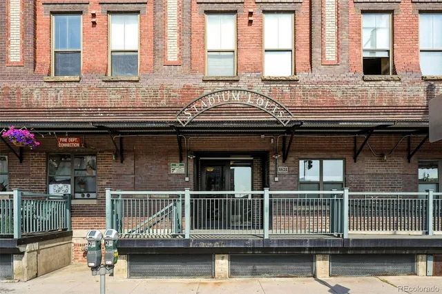 a kitchen with stainless steel appliances granite countertop a sink a refrigerator and wooden cabinets