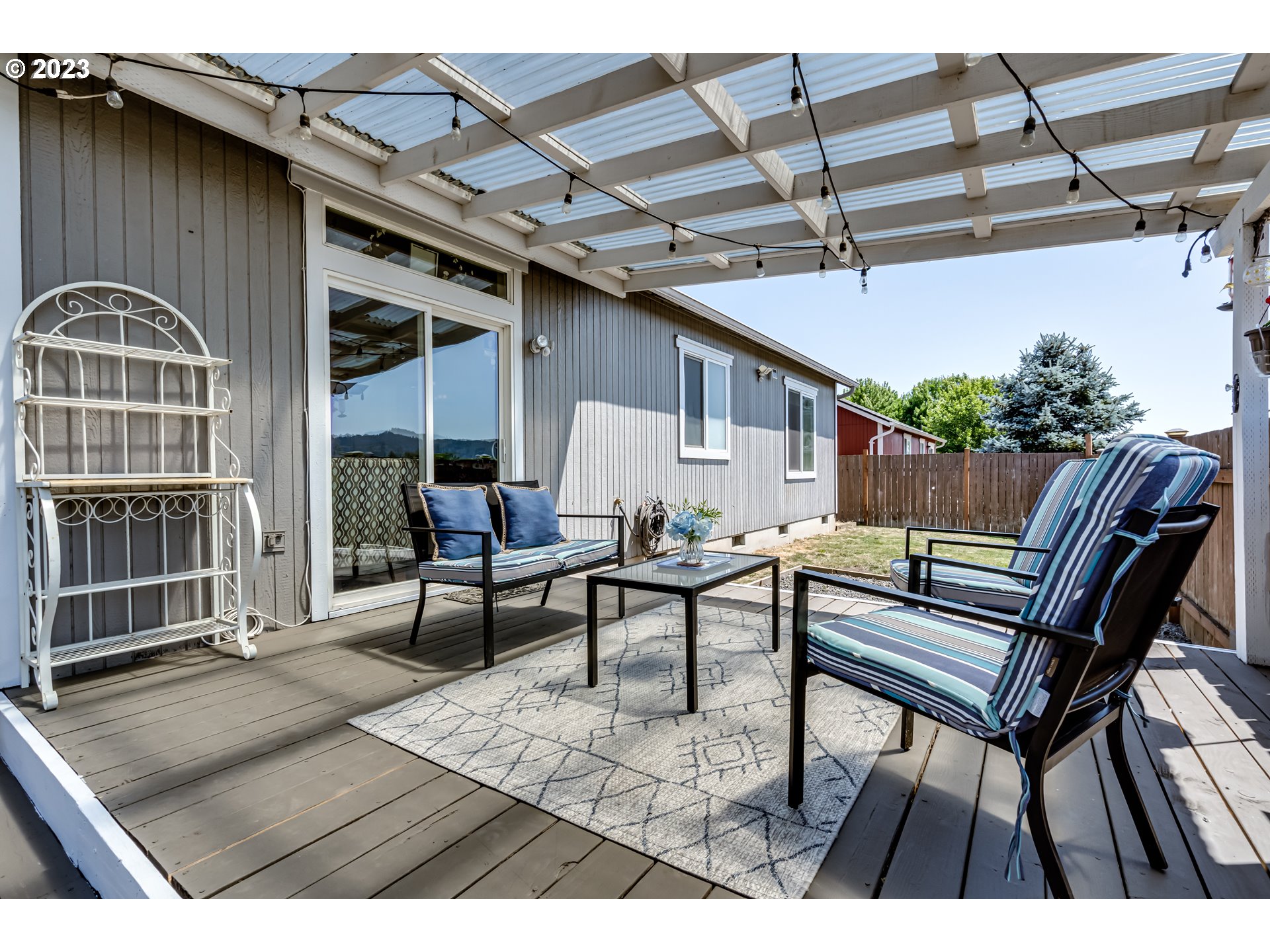 1616 South 59th Street Springfield, OR 97478 - Photo 39 of 44 a view of a patio with table and chairs with wooden floor and fence
