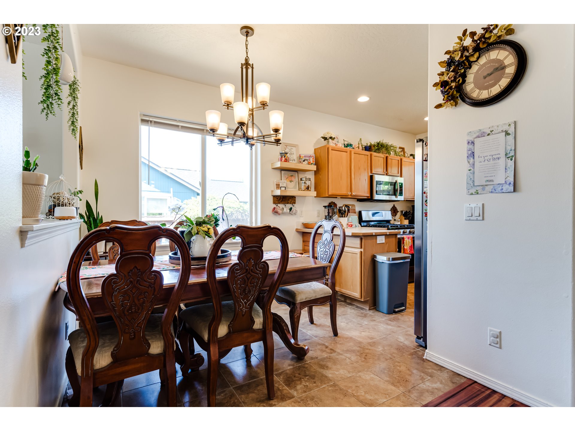1616 South 59th Street Springfield, OR 97478 - Photo 9 of 44 a view of a dining room and livingroom with furniture a chandelier and wooden floor