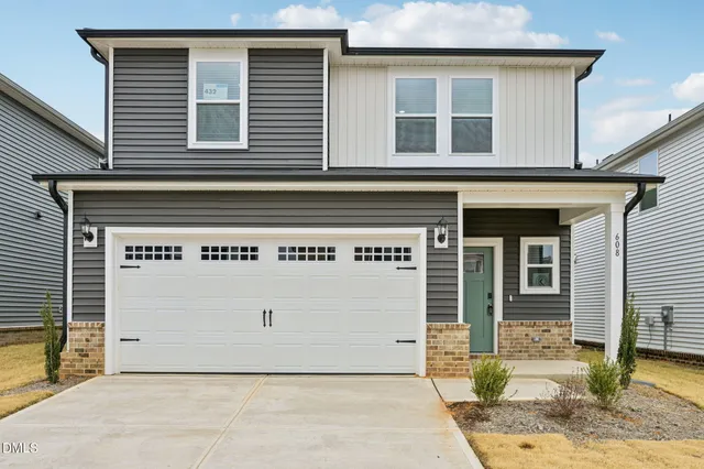 a front view of a house with garage