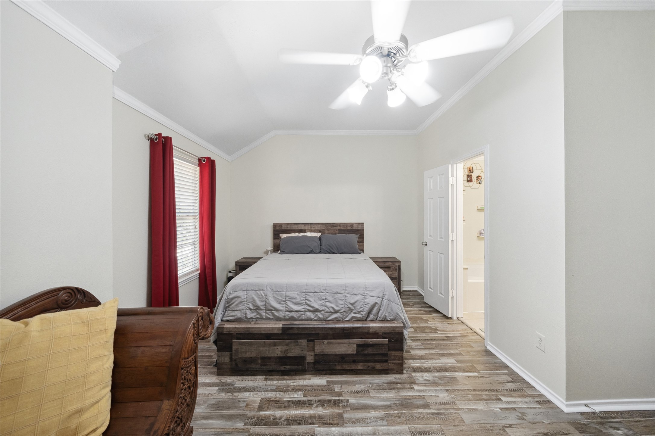 38 Wineberry Place Spring, TX 77382 - Photo 21 of 32 a bedroom with a bed and a chandelier