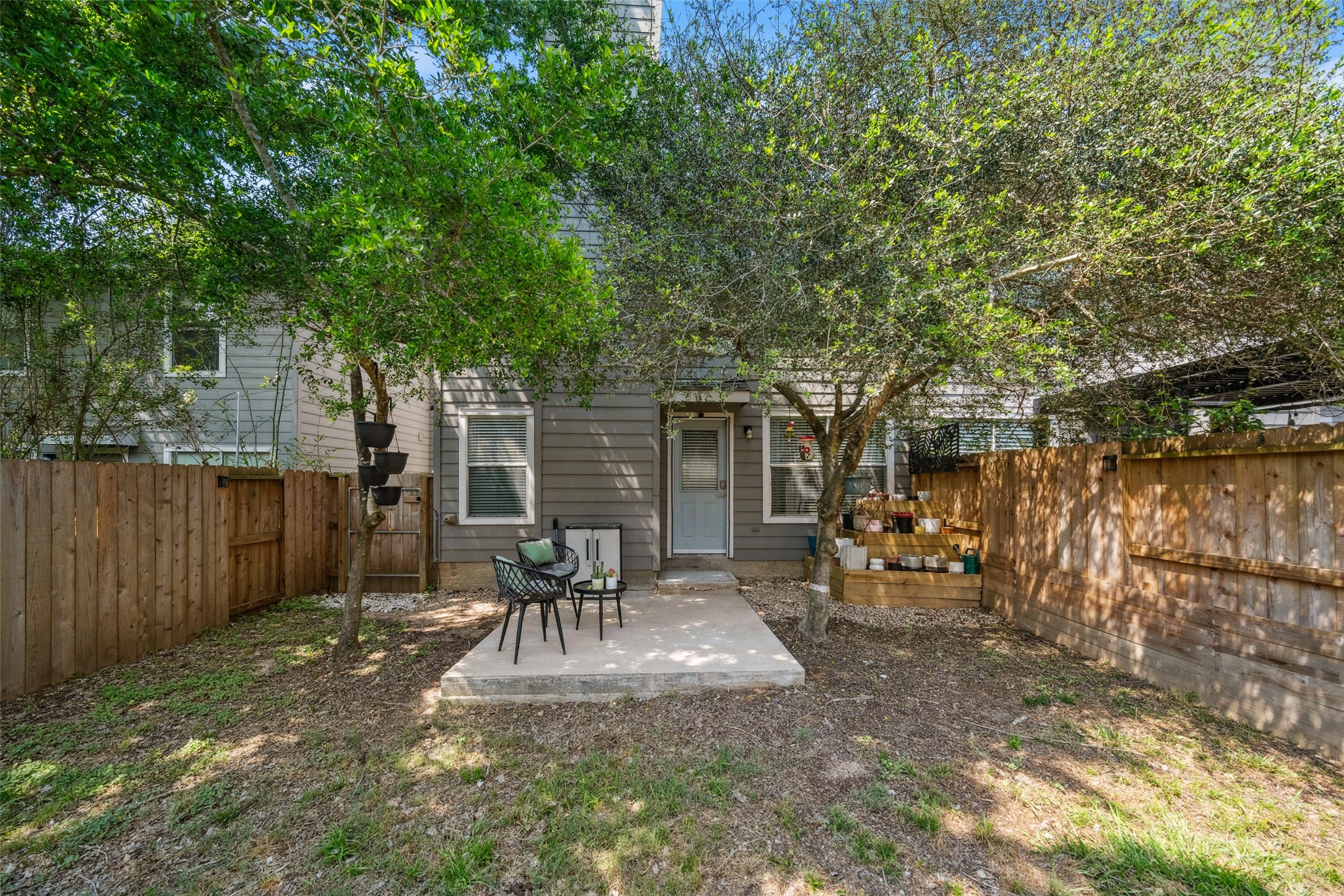 38 Wineberry Place Spring, TX 77382 - Photo 31 of 32 a view of a backyard with table and chairs and wooden fence