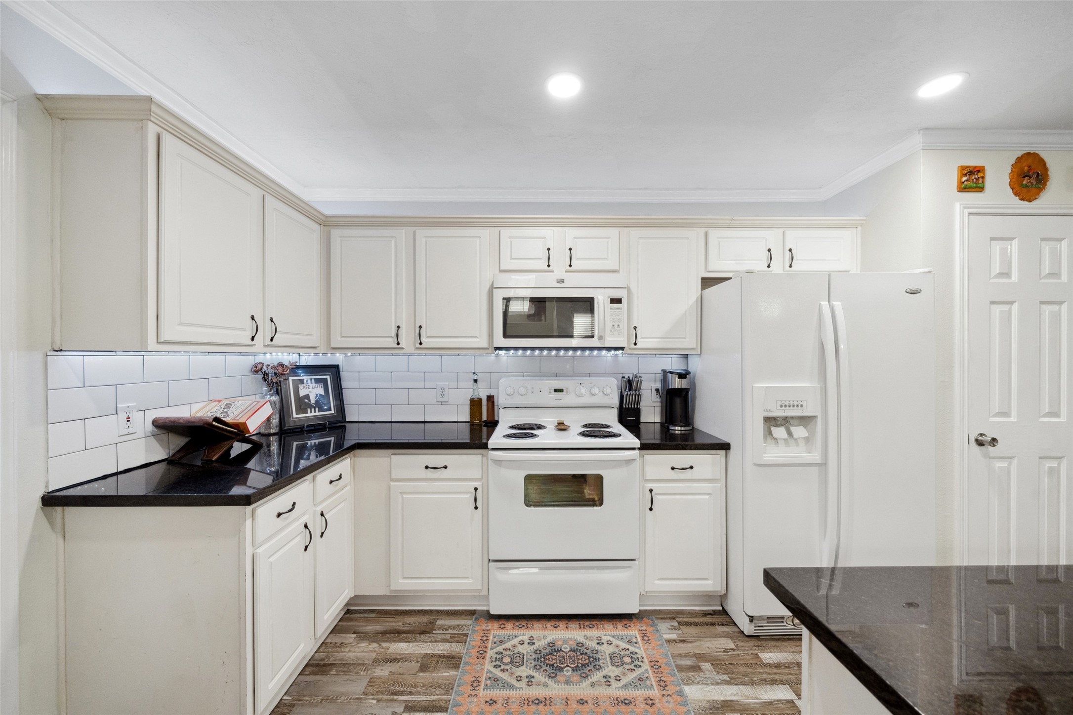 38 Wineberry Place Spring, TX 77382 - Photo 5 of 32 a kitchen with a sink a stove and refrigerator