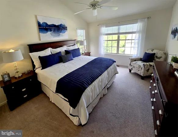 a spacious bedroom with a bed and window
