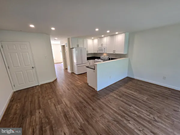 a view of kitchen with wooden floor and electronic appliances