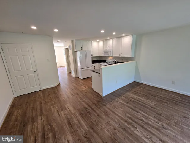 a view of kitchen with wooden floor and electronic appliances
