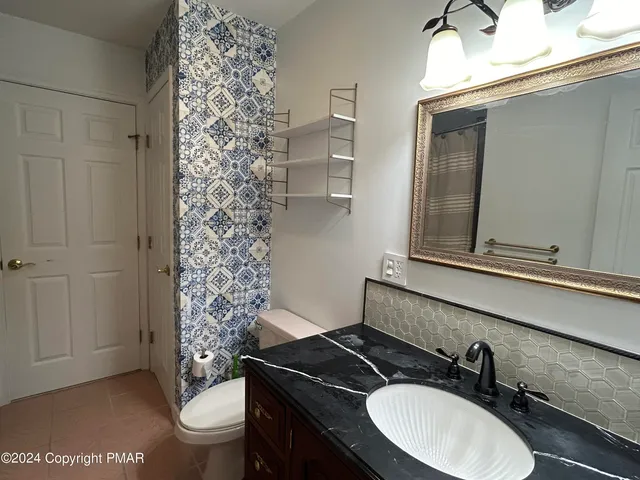 a bathroom with a toilet and a shower curtain