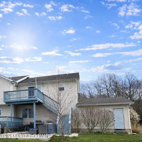 a view of a house with a yard and sitting area