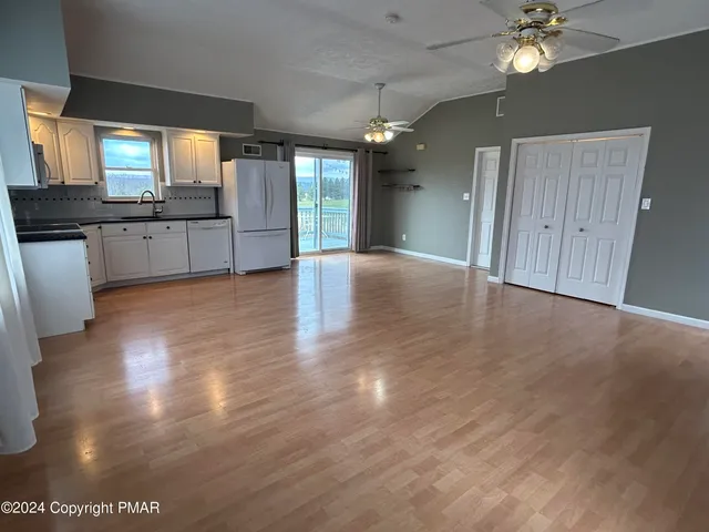 a view of a kitchen with a sink and a window