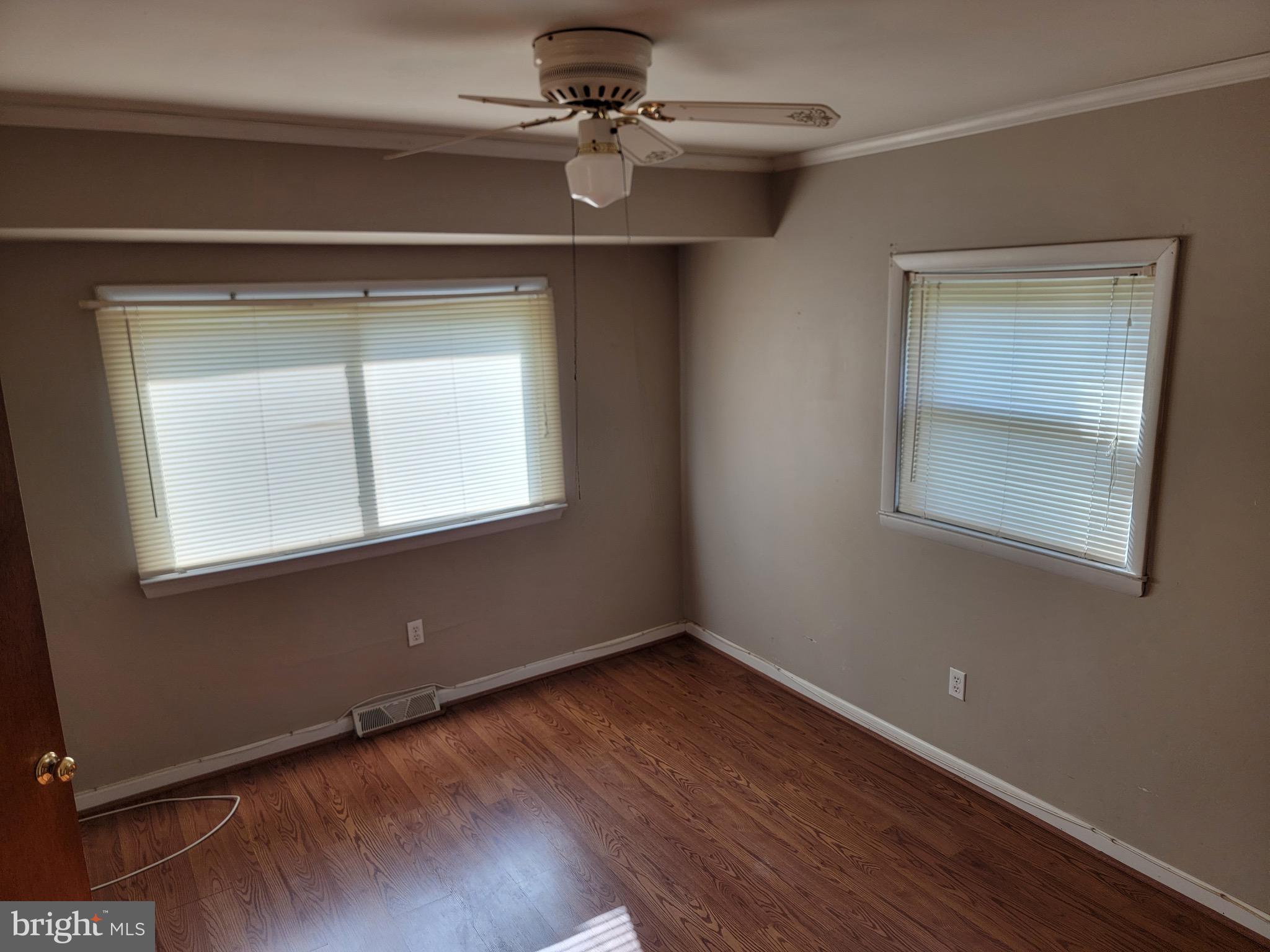 10816 Livingston Road Fort Washington, MD 20744 - Photo 12 of 26 an empty room with a window and wooden floor