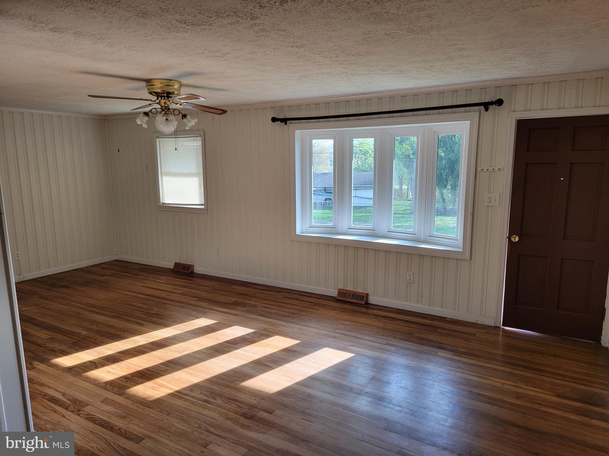10816 Livingston Road Fort Washington, MD 20744 - Photo 2 of 26 a view of empty room with wooden floor and fan