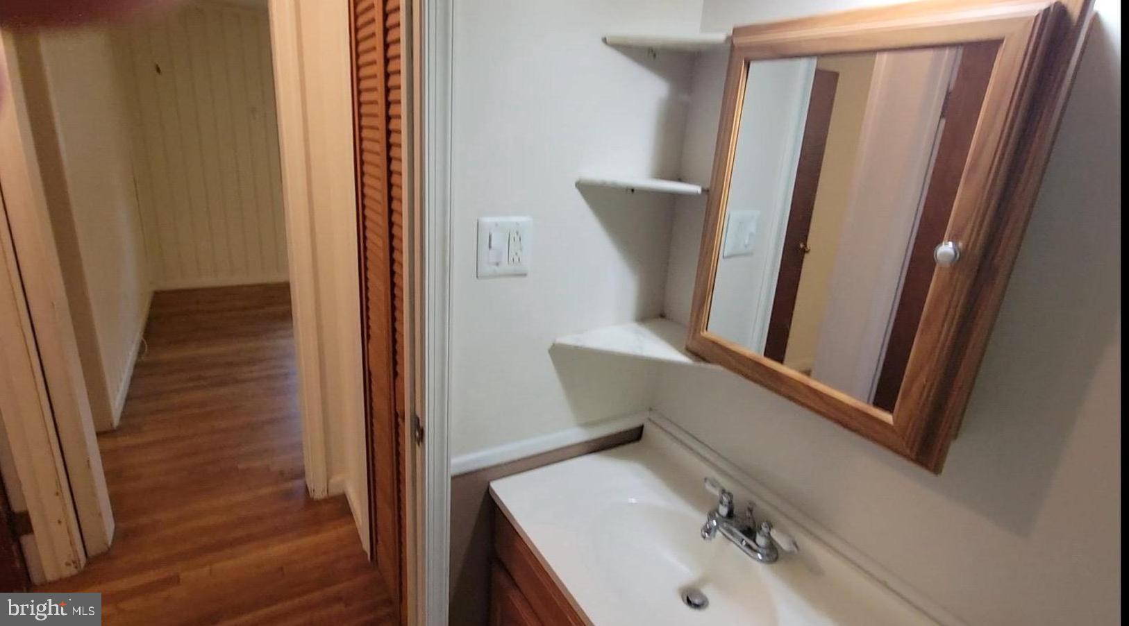 10816 Livingston Road Fort Washington, MD 20744 - Photo 22 of 26 a bathroom with a sink and mirror