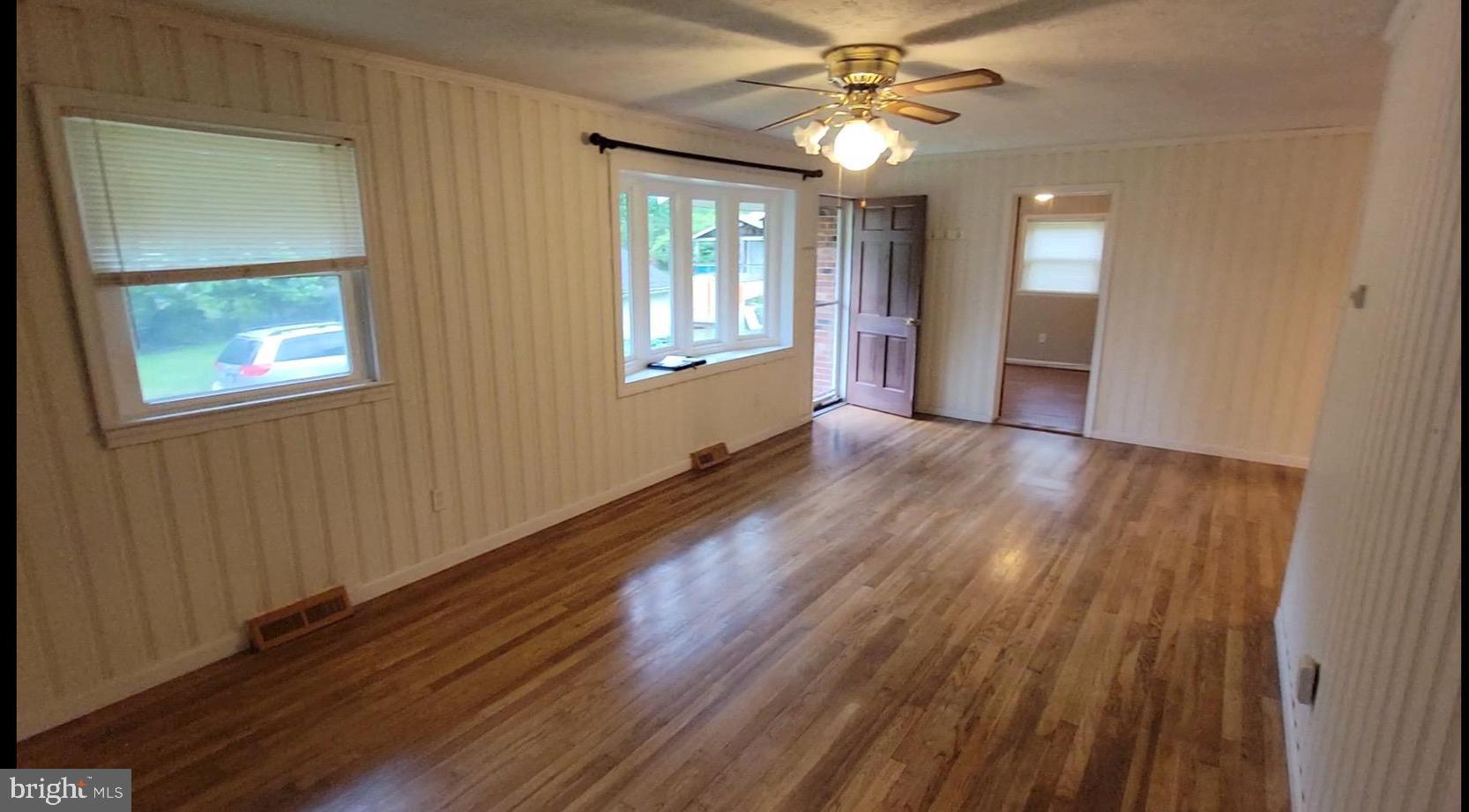 10816 Livingston Road Fort Washington, MD 20744 - Photo 3 of 26 wooden floor in an empty room with a window