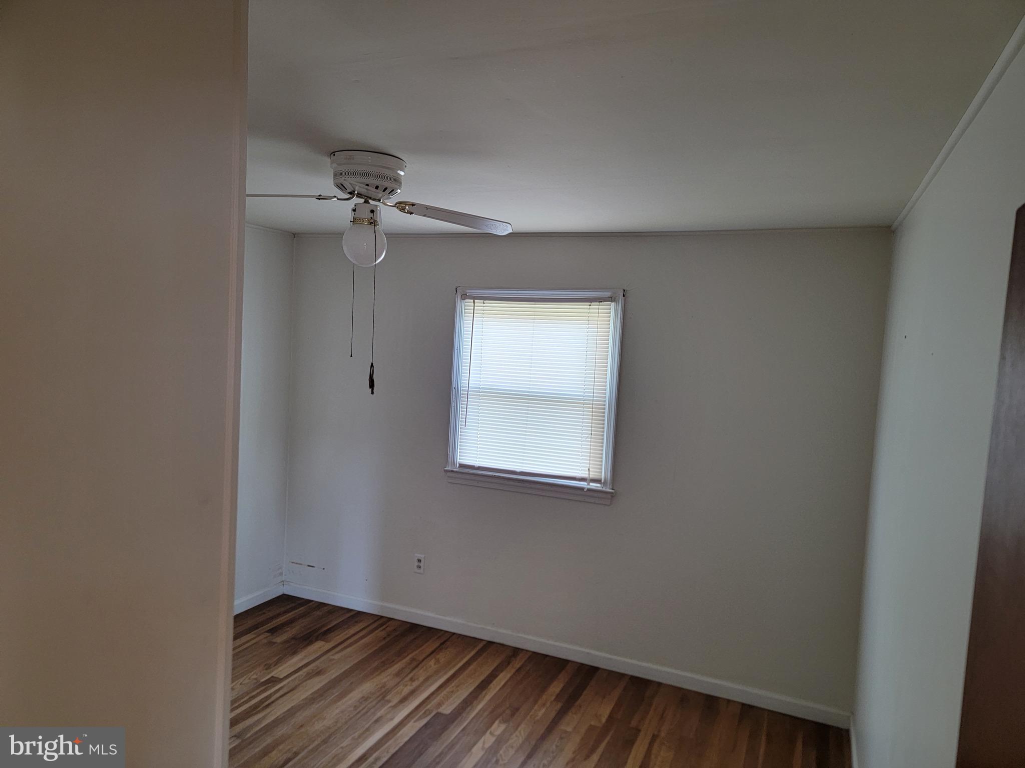 10816 Livingston Road Fort Washington, MD 20744 - Photo 6 of 26 an empty room with a window and a fan