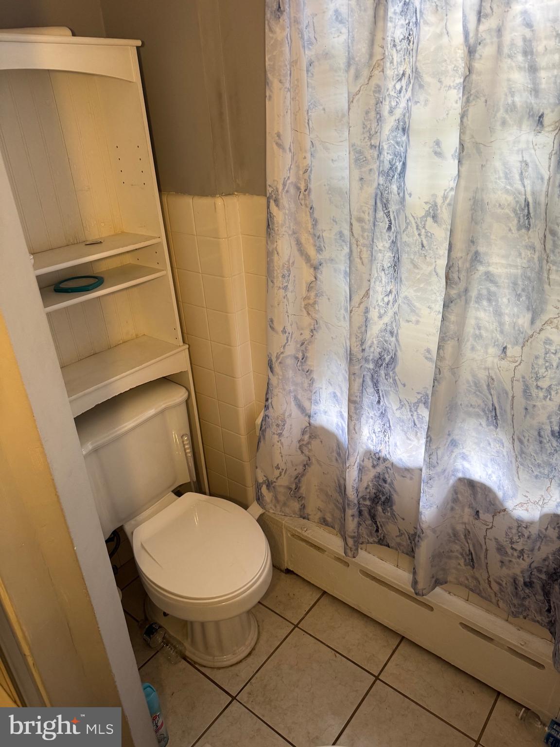 410 Laurel Road Lansdowne, PA 19050 - Photo 11 of 19 a white toilet sitting next to a shower curtain