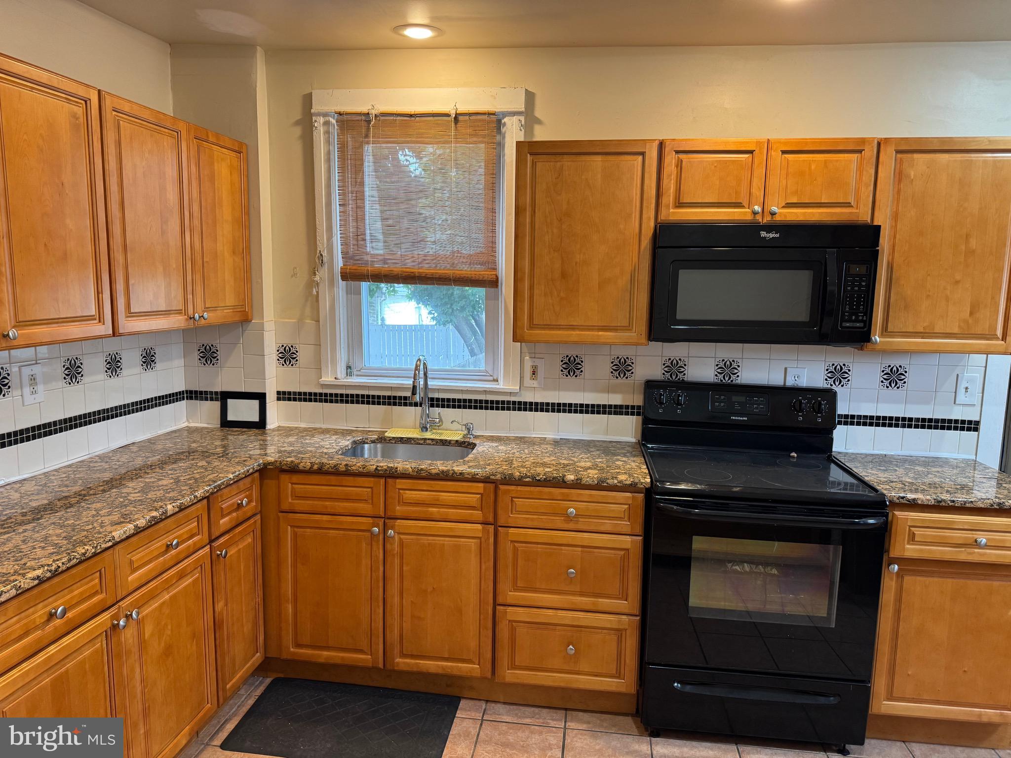 410 Laurel Road Lansdowne, PA 19050 - Photo 2 of 19 a kitchen with a sink stove and microwave