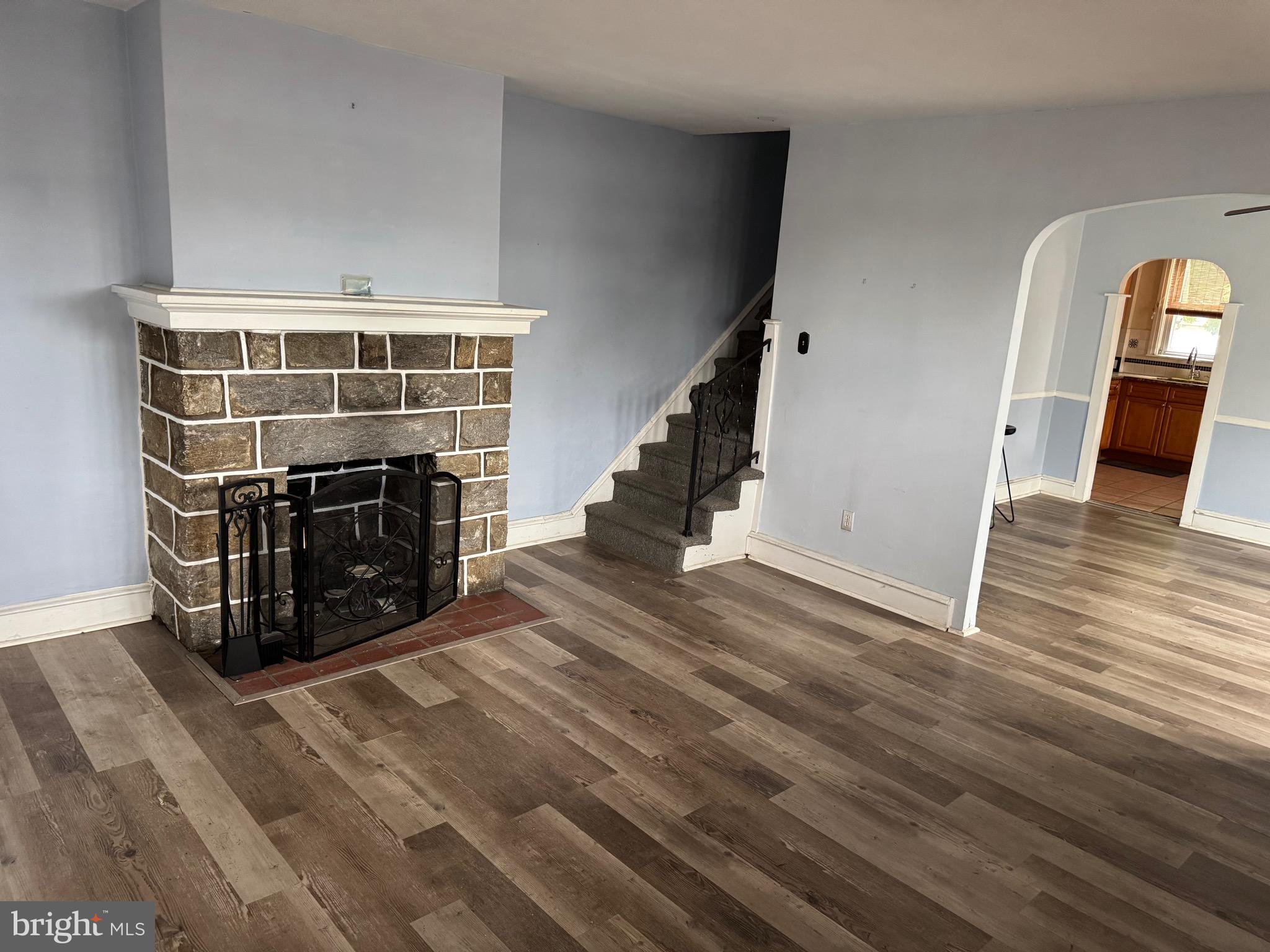 410 Laurel Road Lansdowne, PA 19050 - Photo 3 of 19 a view of an empty room with wooden floor fireplace and a window