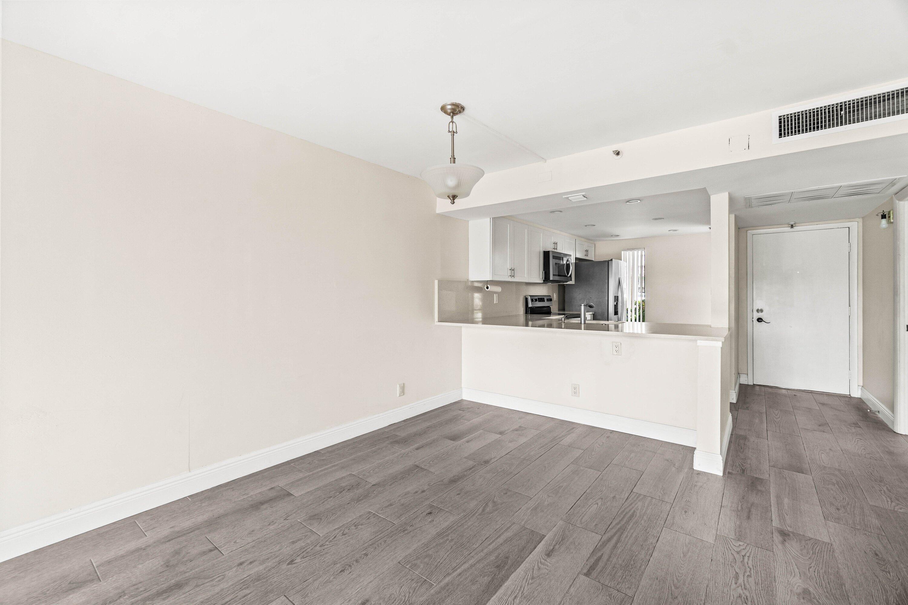 17 Royal Palm Way, Unit 103 Boca Raton, FL 33432 - Photo 10 of 30 a view of a kitchen with wooden floor and window