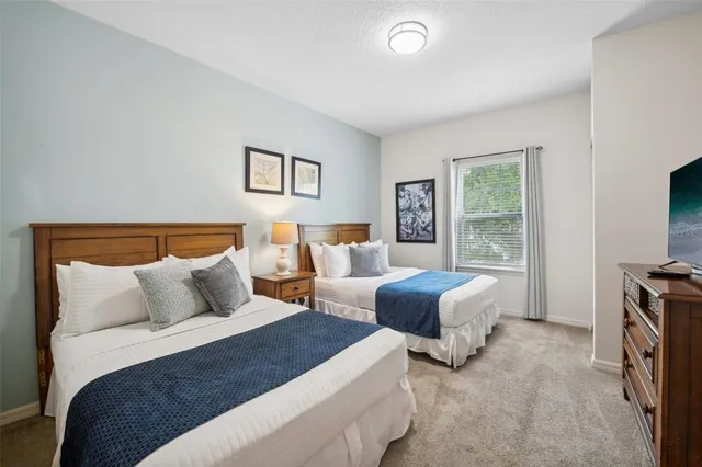 a bedroom with furniture and a flat screen tv