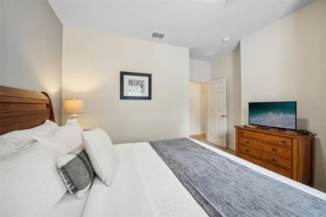 a bedroom with a bed and a flat screen tv