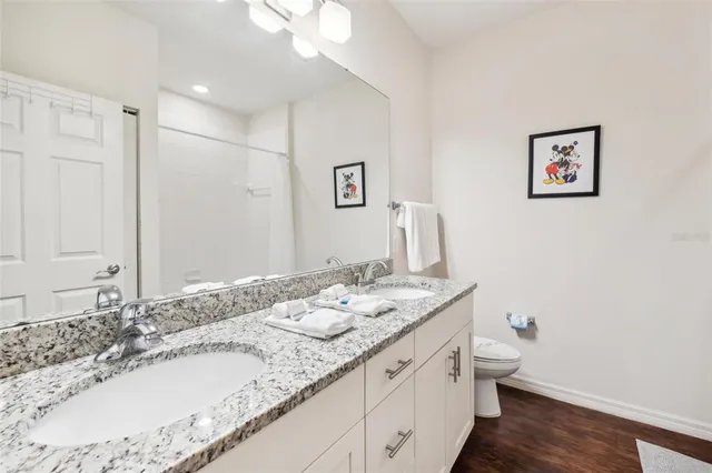a bathroom with a granite countertop sink mirror and vanity