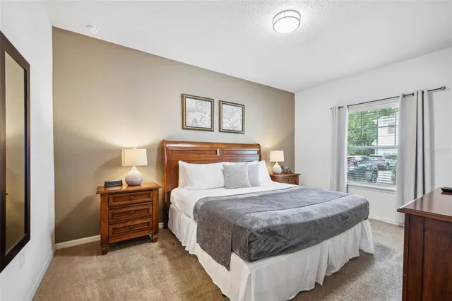 a bedroom with bed and a window