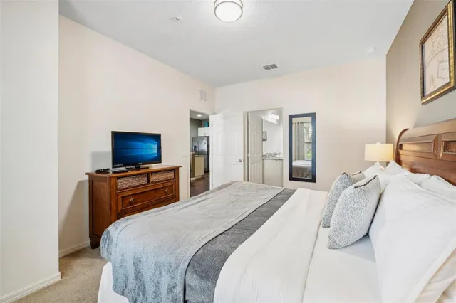 a bedroom with a bed and a television