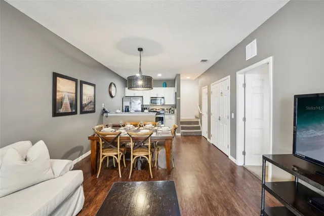 a view of a dining room with furniture and wooden floor