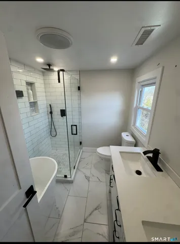 a bathroom with a sink a toilet and mirror