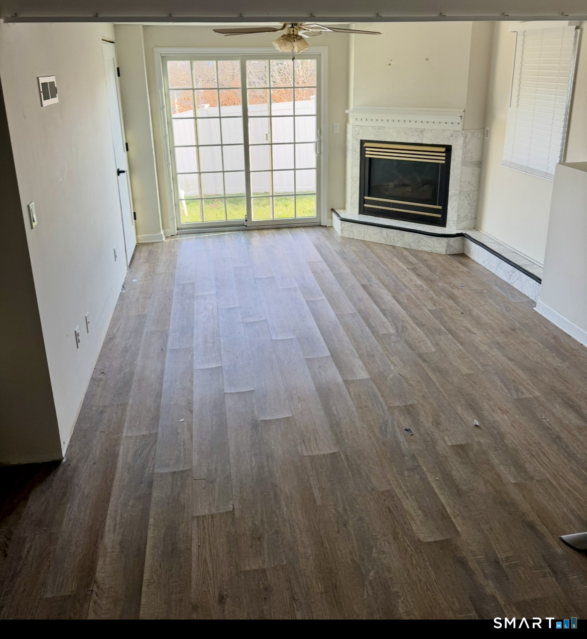 35 Knapps Highway Fairfield, CT 06825 - Photo 19 of 21 a view of empty room with wooden floor and fireplace