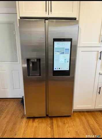 a view of washer and dryer with wooden floor