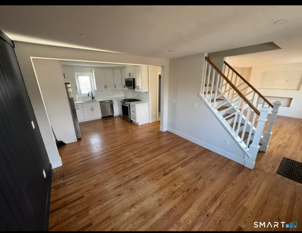 a view of an entryway with wooden floor