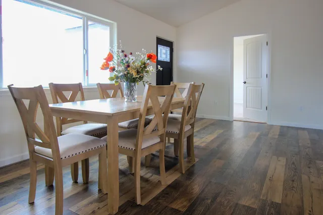 a view of a dining room with furniture and wooden floor