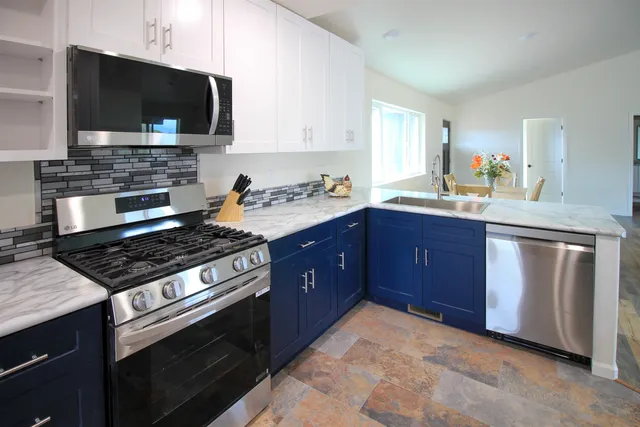 a kitchen with a sink stove and microwave
