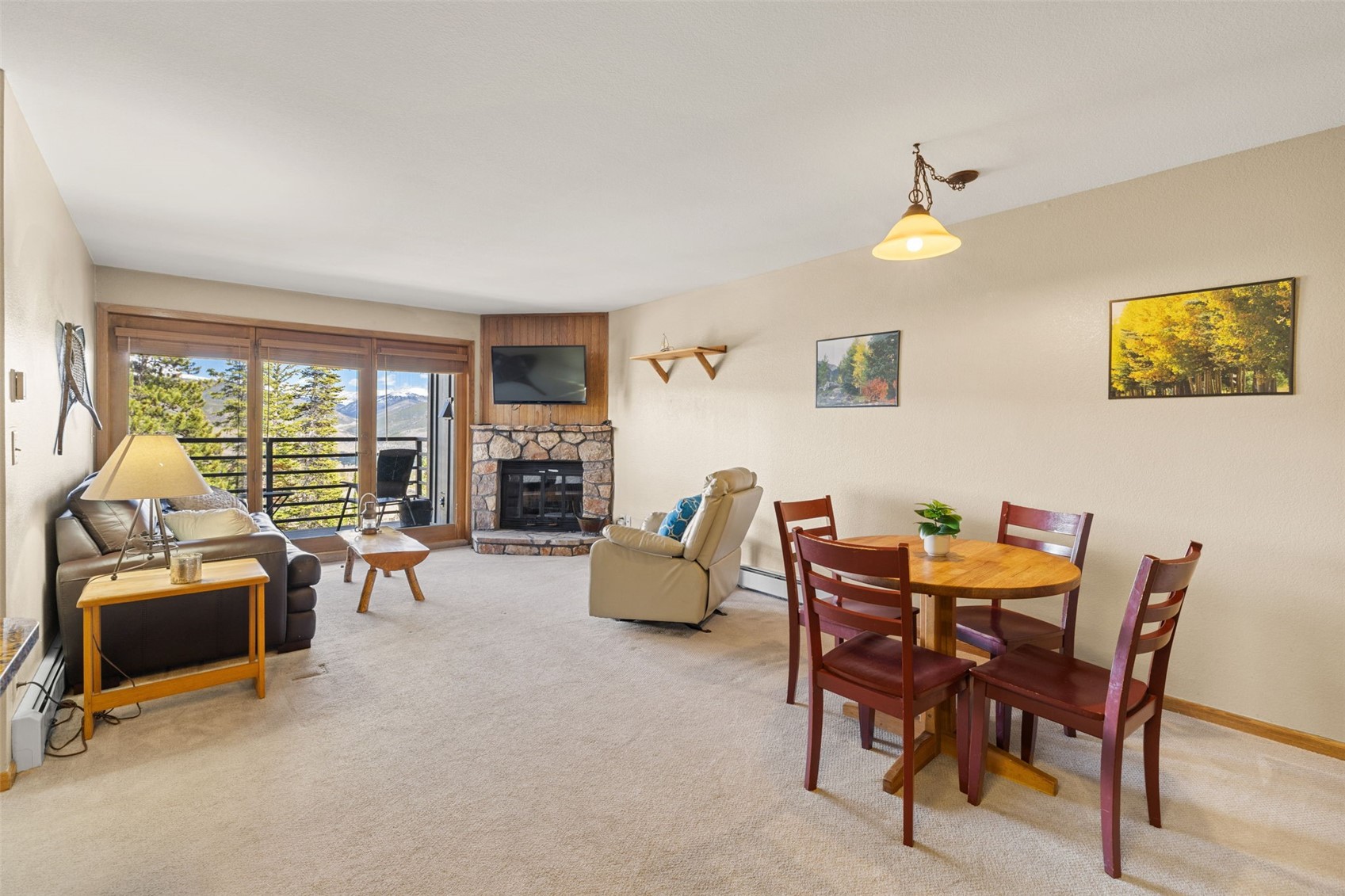 89410 Ryan Gulch Road, Unit DD301 Silverthorne, CO 80498 - Photo 5 of 28 a dining room with furniture and a floor to ceiling window