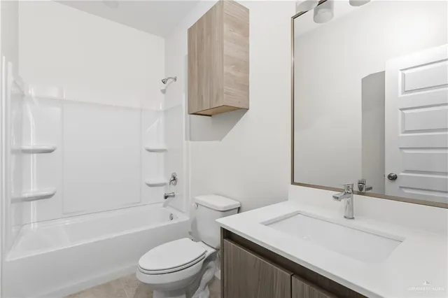 a bathroom with a sink toilet vanity and shower