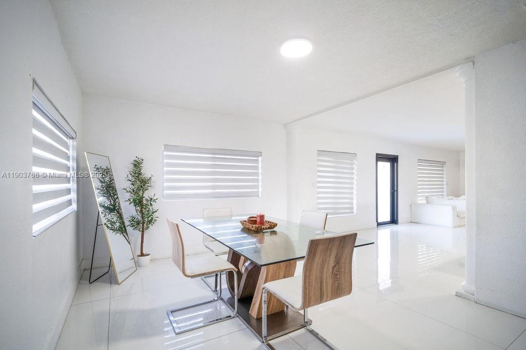 1960 Southwest 128th Court Miami, FL 33175 - Photo 12 of 32 a workspace with furniture and a potted plant