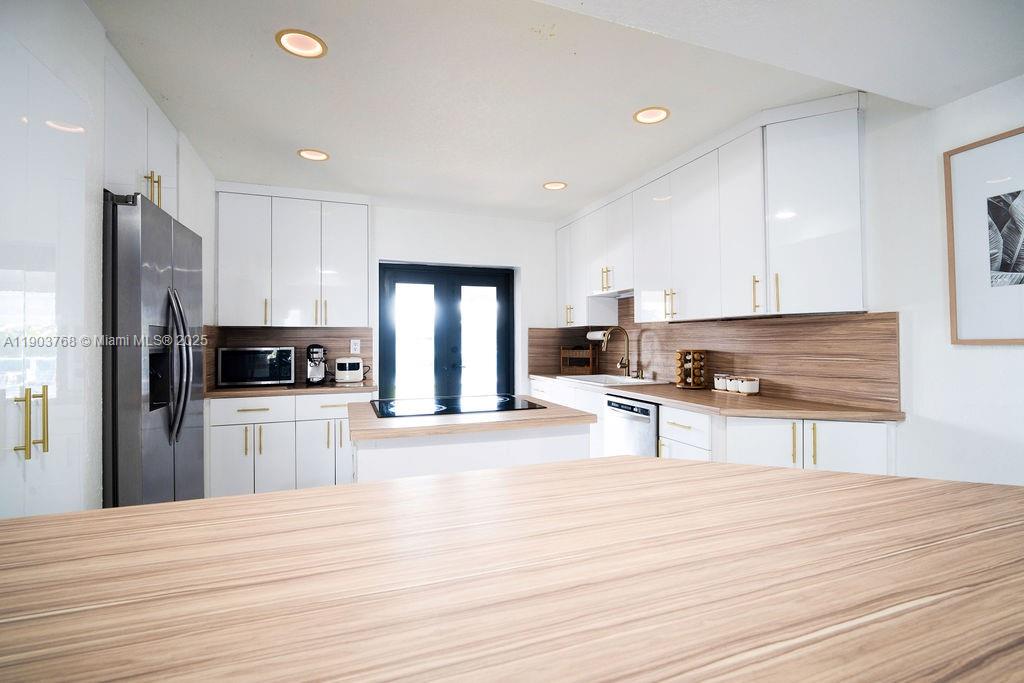 1960 Southwest 128th Court Miami, FL 33175 - Photo 14 of 32 a kitchen with stainless steel appliances kitchen island a refrigerator sink and cabinets