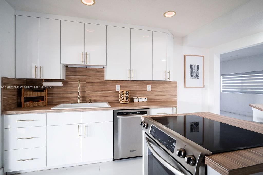 1960 Southwest 128th Court Miami, FL 33175 - Photo 16 of 32 a kitchen with granite countertop a sink stainless steel appliances and cabinets