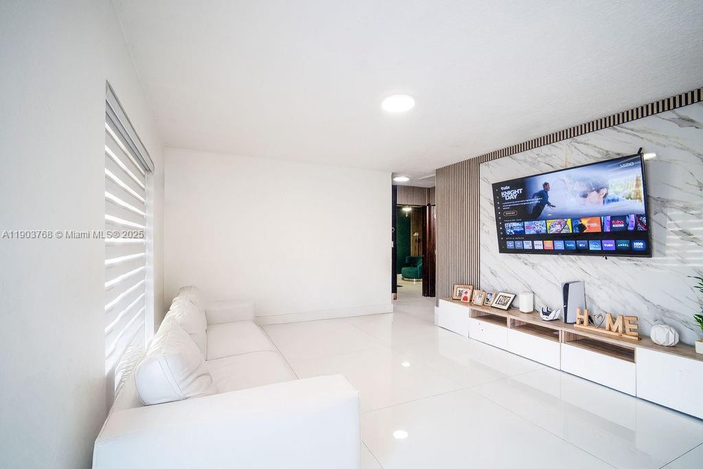 1960 Southwest 128th Court Miami, FL 33175 - Photo 20 of 32 a living room with furniture and a flat screen tv