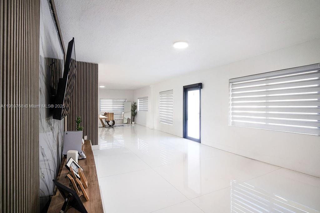 1960 Southwest 128th Court Miami, FL 33175 - Photo 21 of 32 a view of a livingroom with wooden floor and a ceiling fan
