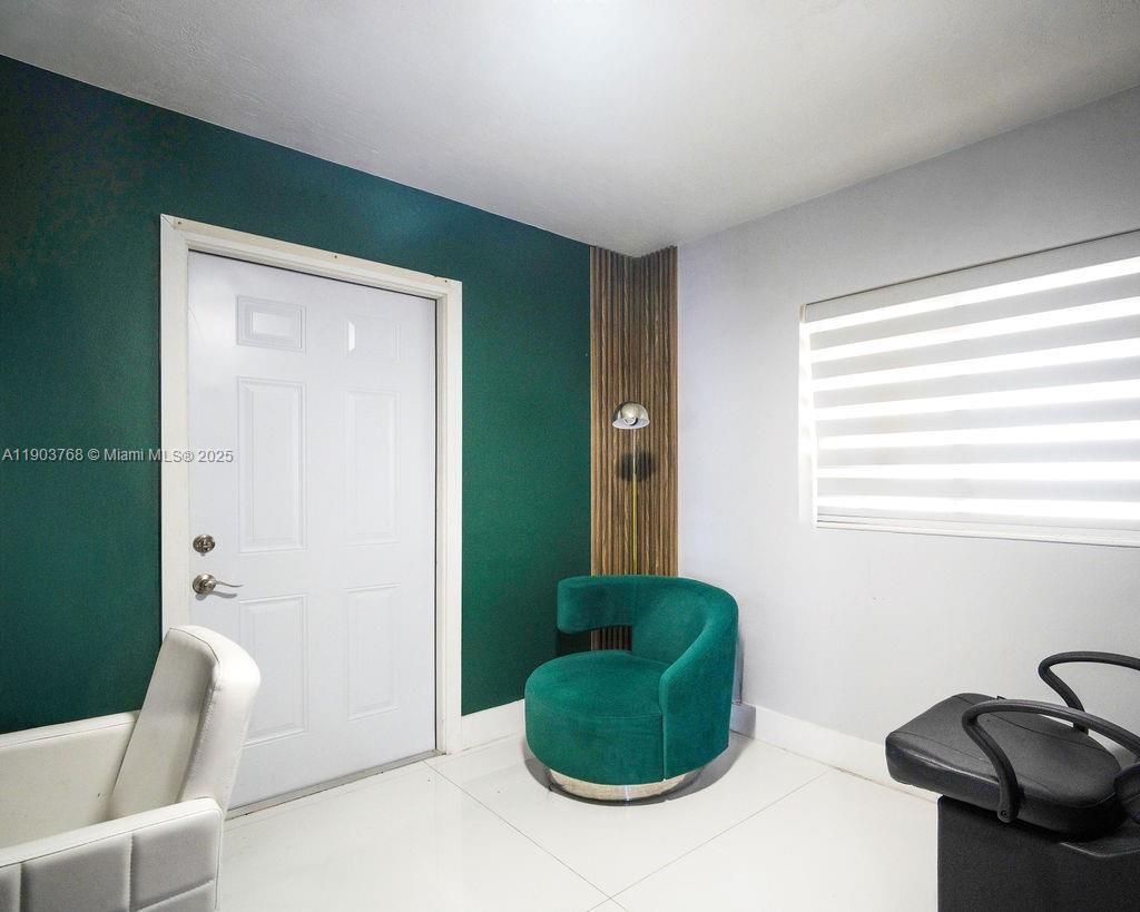 1960 Southwest 128th Court Miami, FL 33175 - Photo 22 of 32 a living room with furniture and a chair