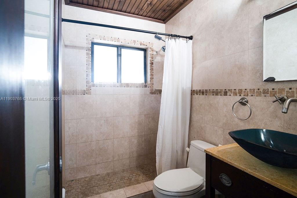 1960 Southwest 128th Court Miami, FL 33175 - Photo 23 of 32 a bathroom with a sink a toilet and shower