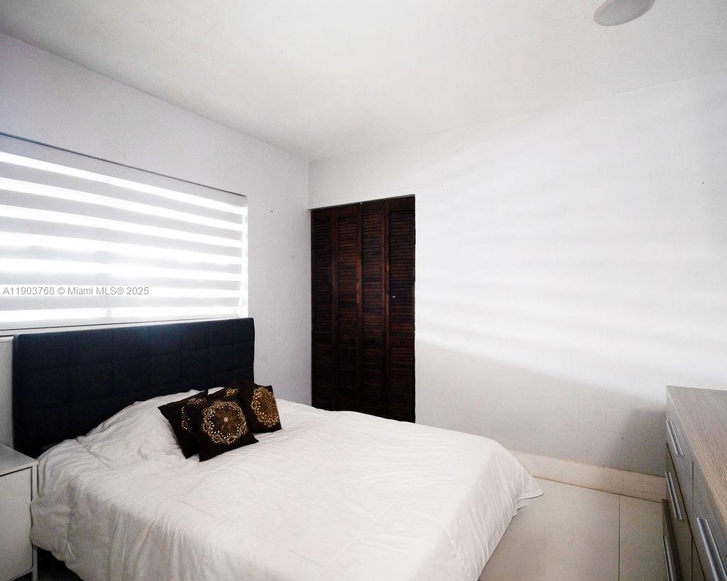 1960 Southwest 128th Court Miami, FL 33175 - Photo 24 of 32 a bedroom with a bed and a window