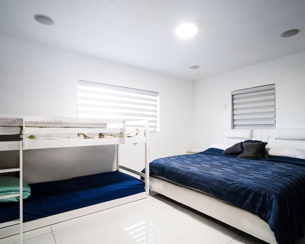 1960 Southwest 128th Court Miami, FL 33175 - Photo 25 of 32 a spacious bedroom with a bed and a window