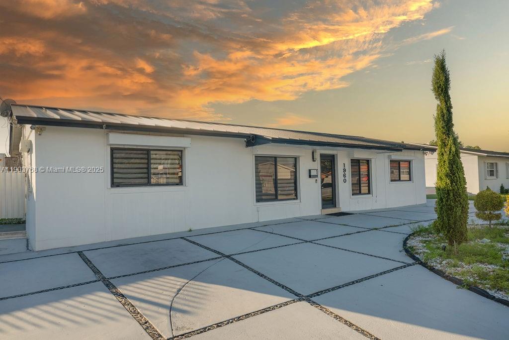 1960 Southwest 128th Court Miami, FL 33175 - Photo 28 of 32 front view of a house with a bench