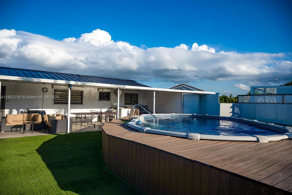 1960 Southwest 128th Court Miami, FL 33175 - Photo 30 of 32 a view of a house with backyard and sitting area