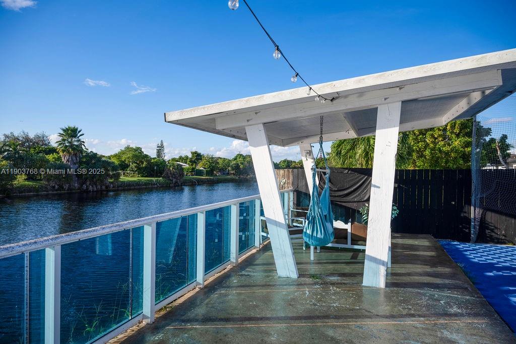 1960 Southwest 128th Court Miami, FL 33175 - Photo 32 of 32 a patio with hardwood chairs and table