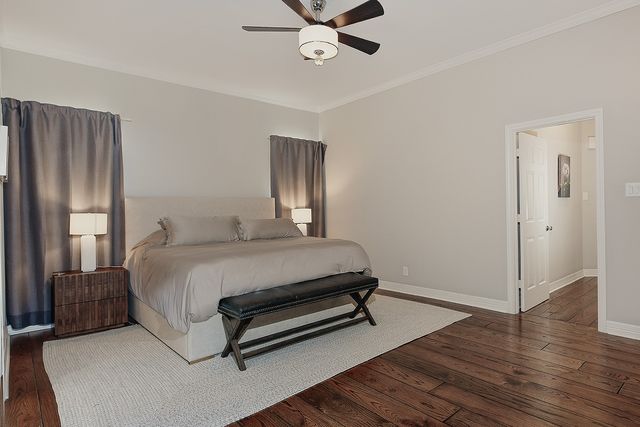 a spacious bathroom with a tub sink and mirror