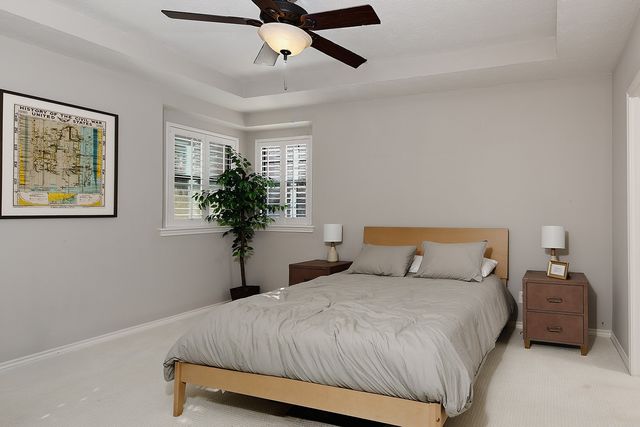 a front view of a house with swimming pool and porch